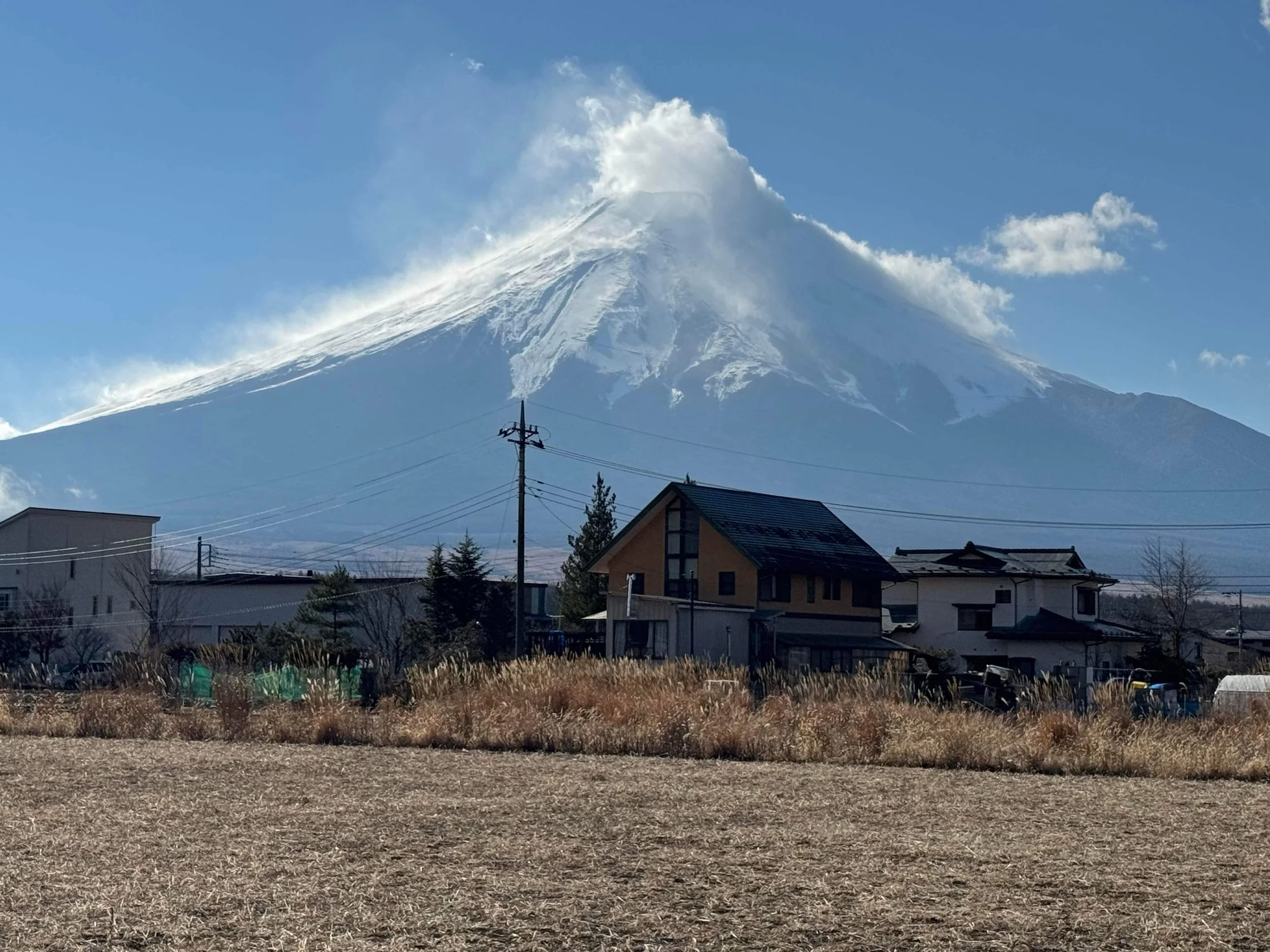 Mount Fuji with a cloud cap seen from rural fields near Oshino