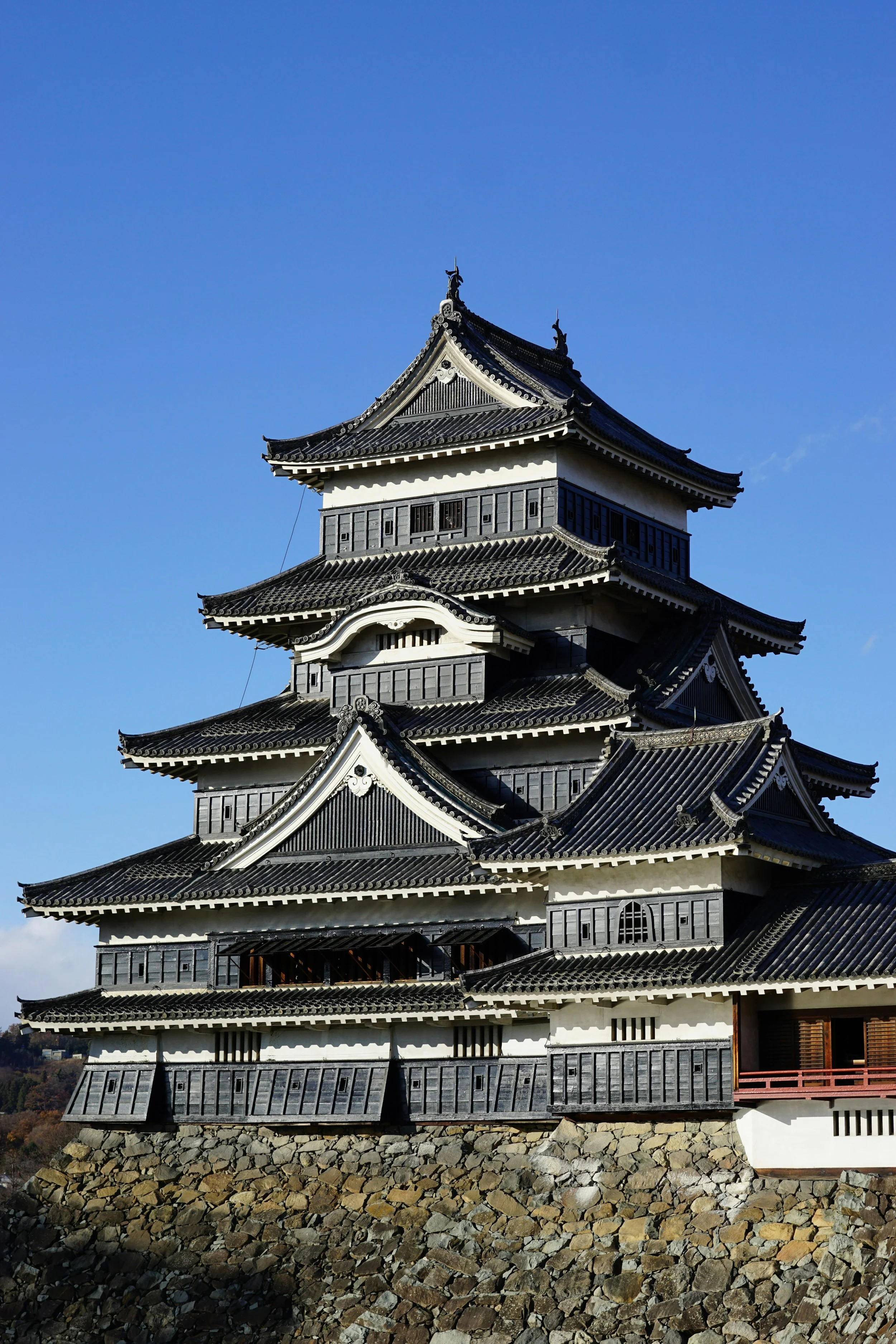 Matsumoto Castle main keep (tenshu) against a blue sky, Nagano