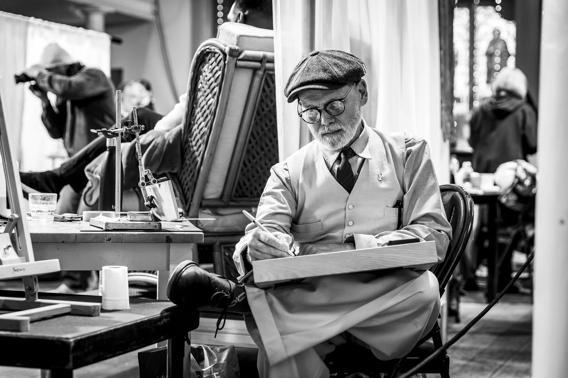 artist in black and white painting a portrait