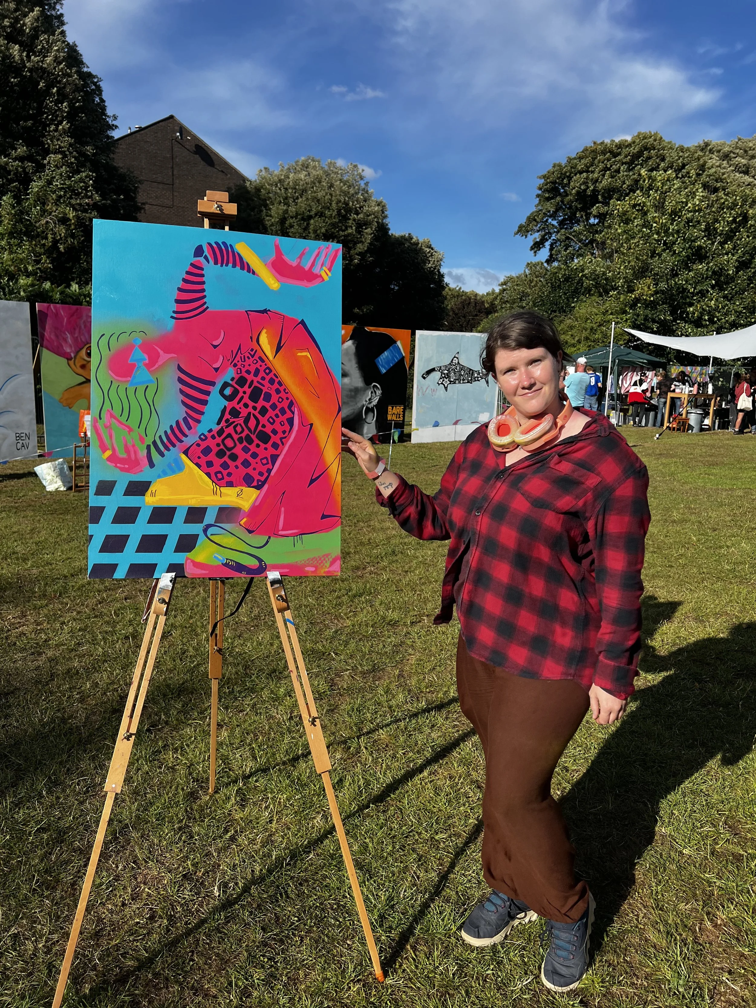 artist stood next to her work