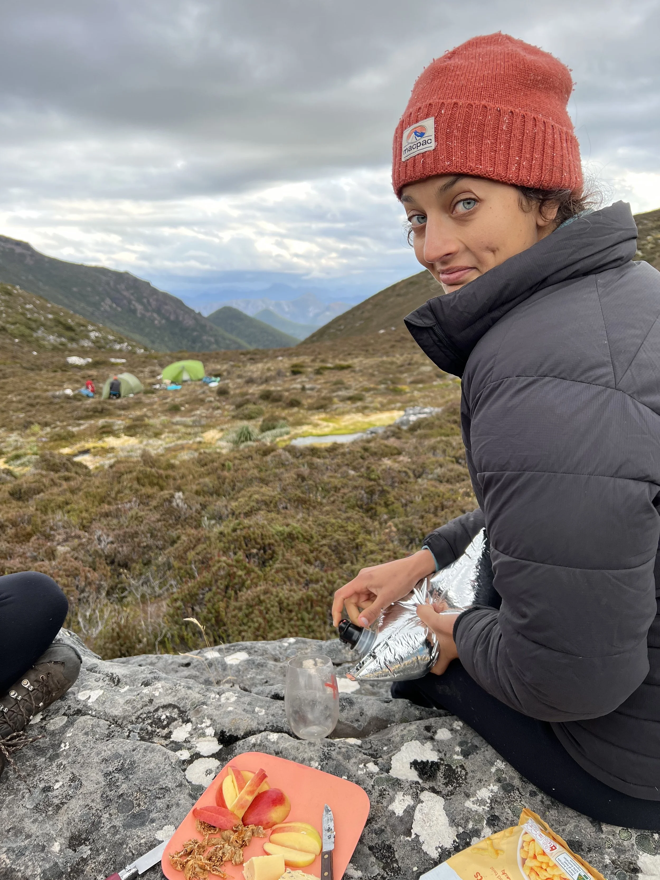 Cheese and wine on a mountain top in Mount Field National Park in Tasmania near hobart. Sunset camp with the girls laughing and chatting before camp dinner.