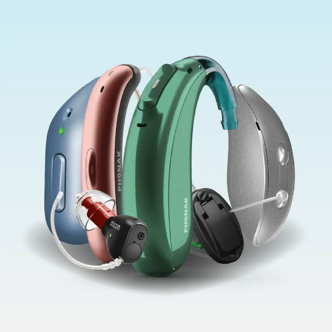 A group of modern hearing aids of different colours and styles