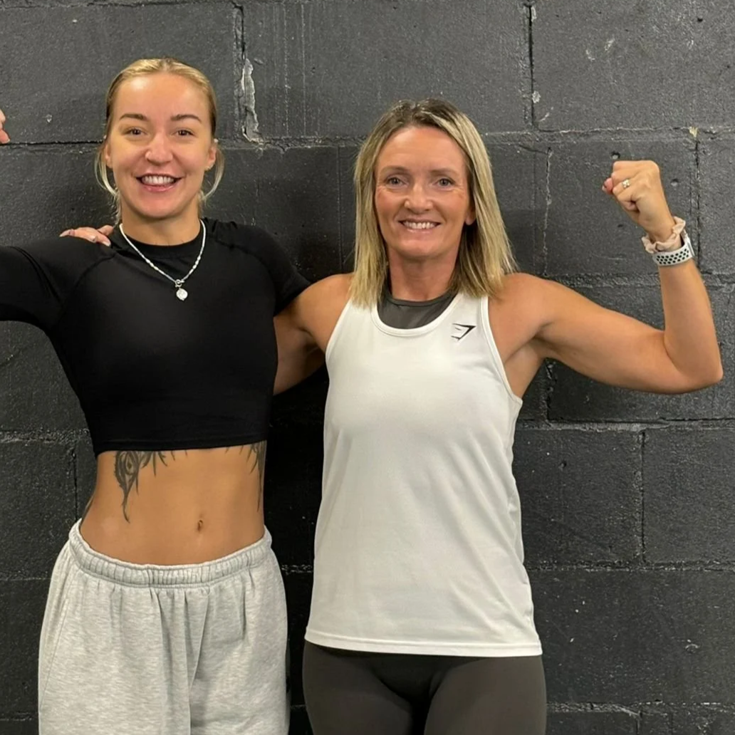 Strength coach Amy and her client Nikki, celebrating her journey from all or nothing training to sustainable strength and confidence.