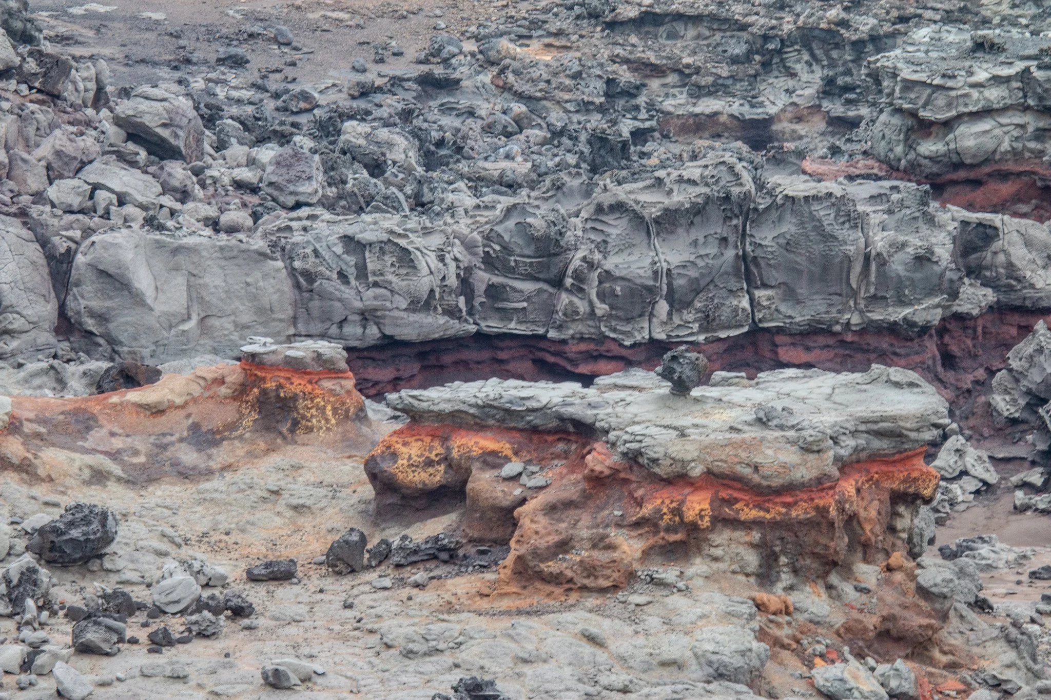 Layered volcanic lava rock formations and eroded coastal shelf surrounding Nakalele Blowhole on Maui’s northwest coast in the West Maui Mountains.