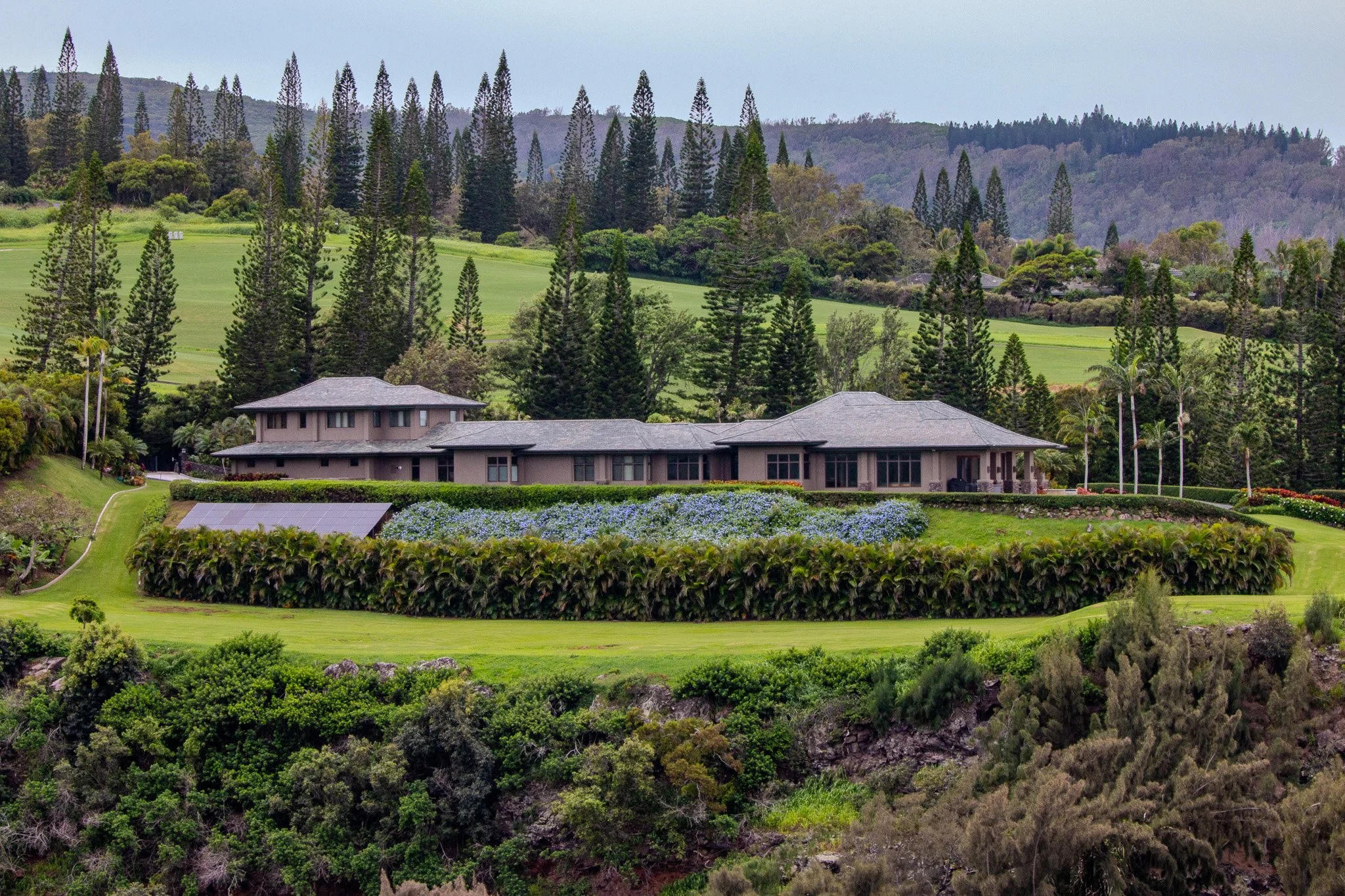 Estate home and green hillside landscape below the West Maui Mountains between Kapalua and  Nakalele Point on Maui