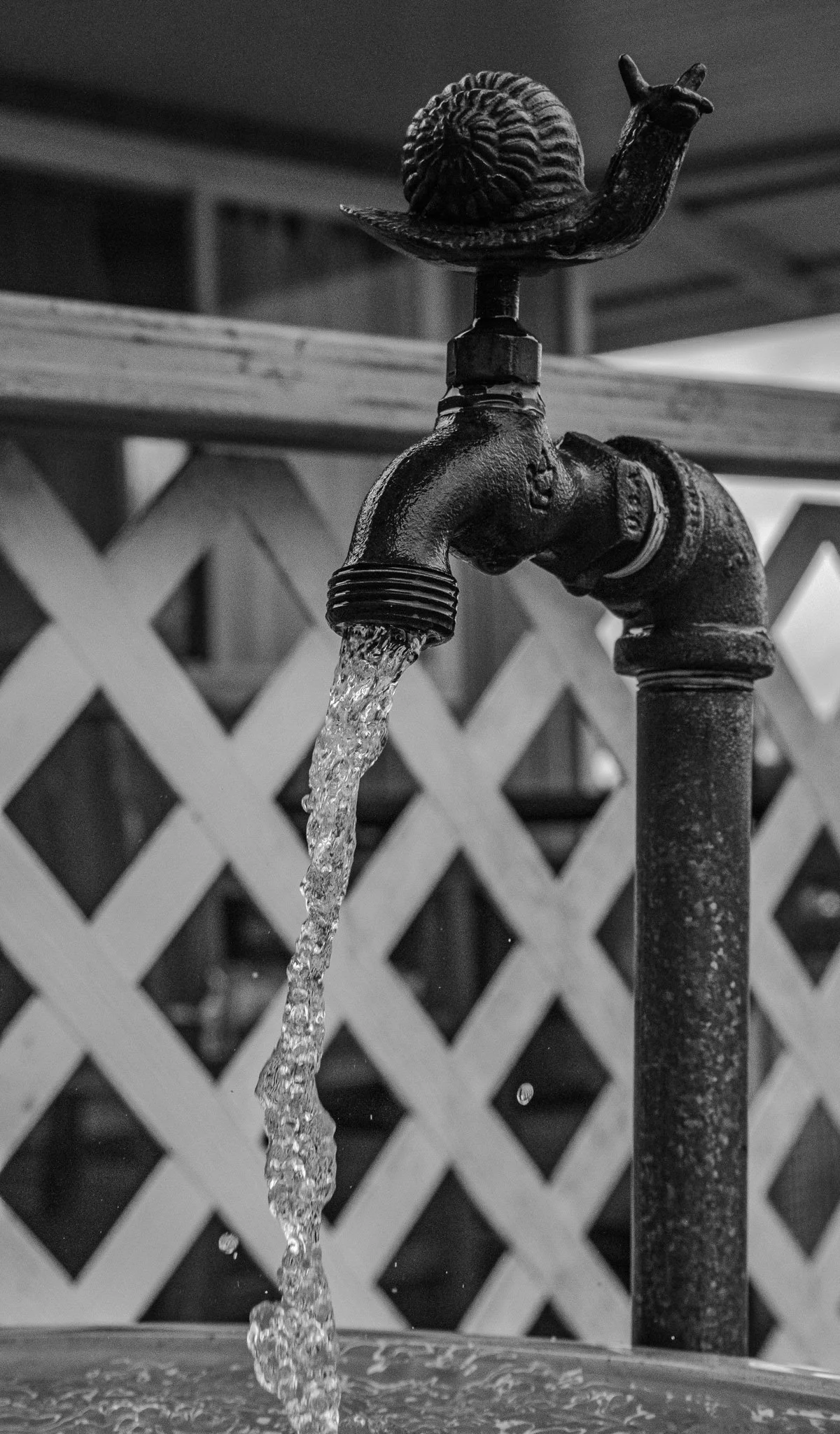 Black and white Kula Maui water spigot framed wall art featuring flowing water and textured metal detail for modern and rustic interior decor