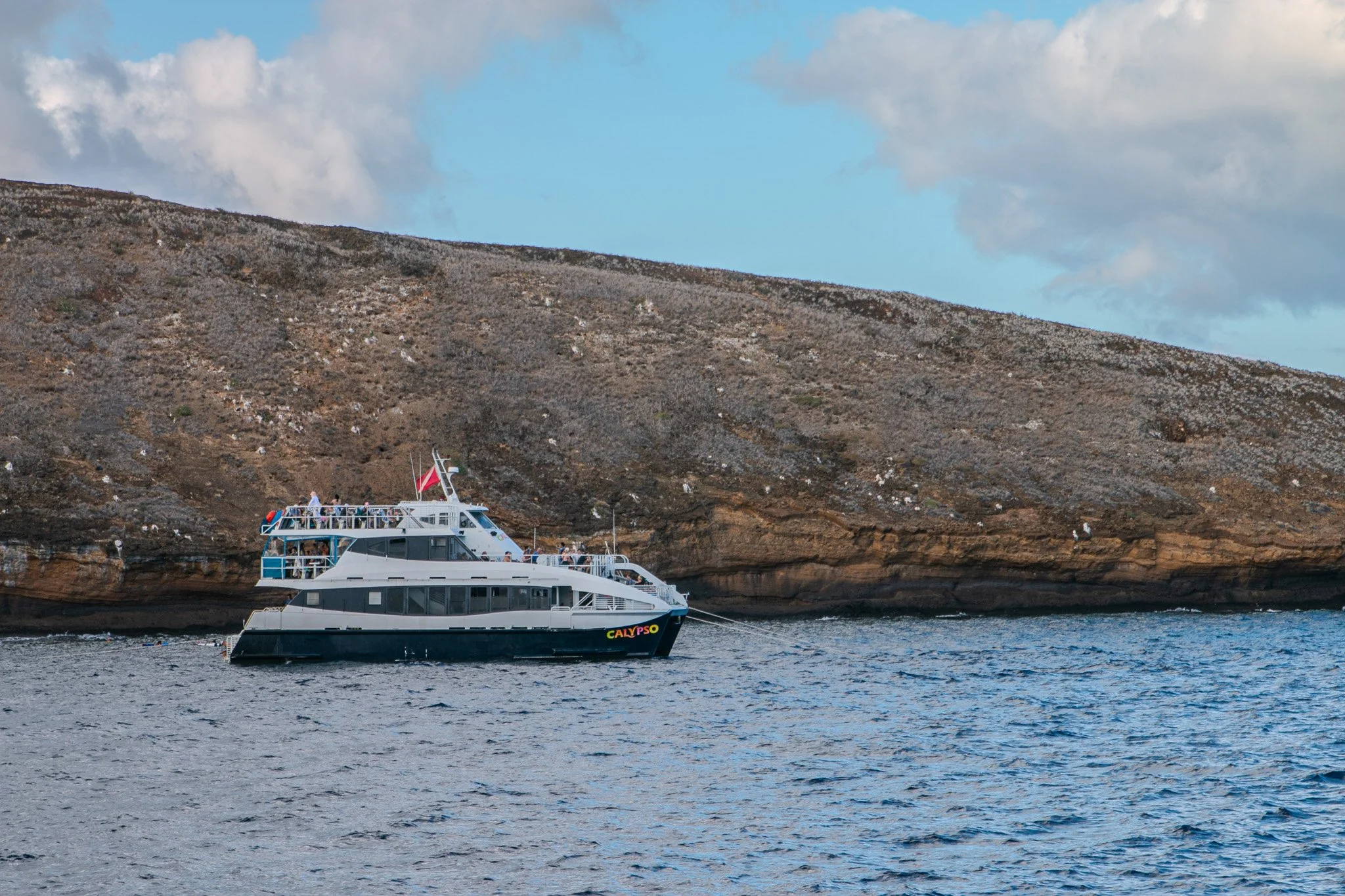 The Calypso snorkel charter anchored along the volcanic wall of Molokini Crater marine sanctuary off Maui’s southern coast.