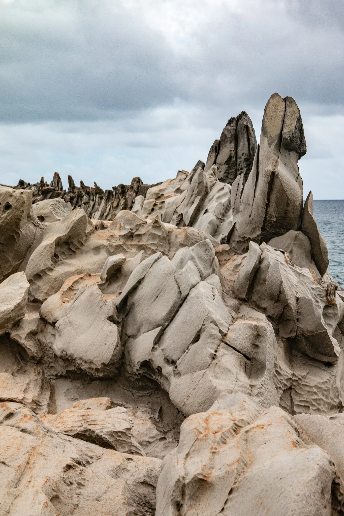 Jagged lava formations known as the Dragon’s Teeth rise along the Kapalua shoreline, their sharp ridges shaped by centuries of wind, salt spray, and pounding waves from the Pailolo Channel.