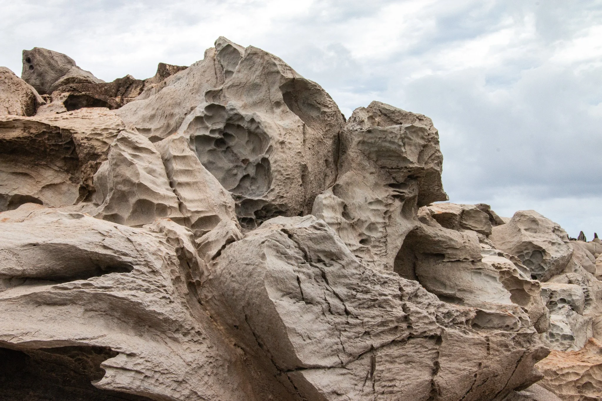 Eroded basalt lava rock at Dragon’s Teeth along the Kapalua coastline on Maui showing honeycomb weathering patterns