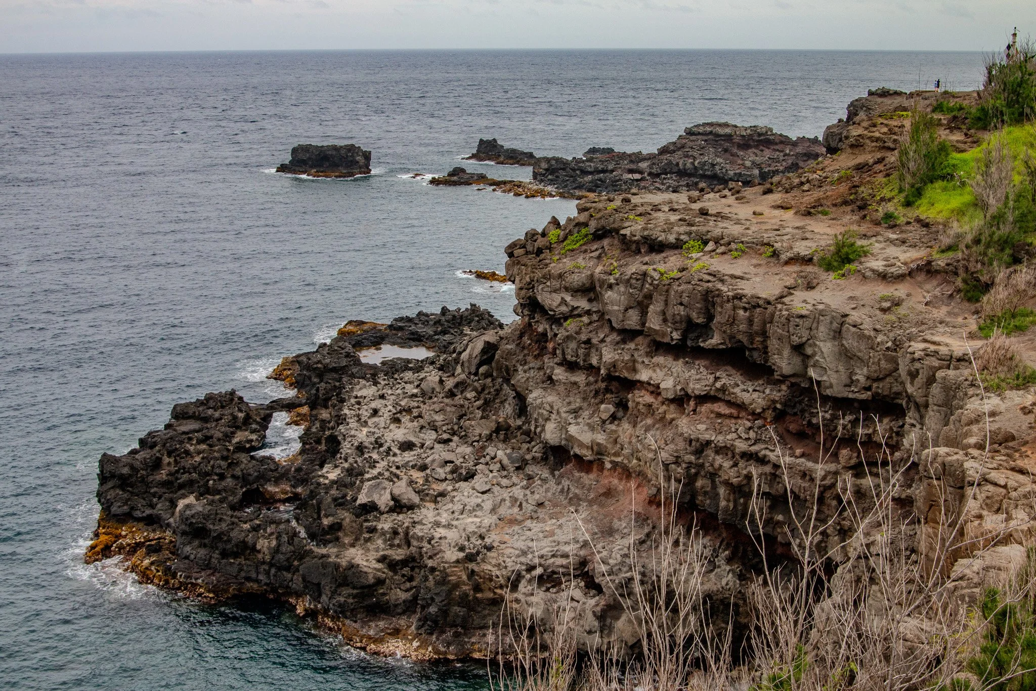 Volcanic coastal cliffs and rugged lava shoreline along Maui’s northwest coast near Nakalele Blowhole in the West Maui Mountains.