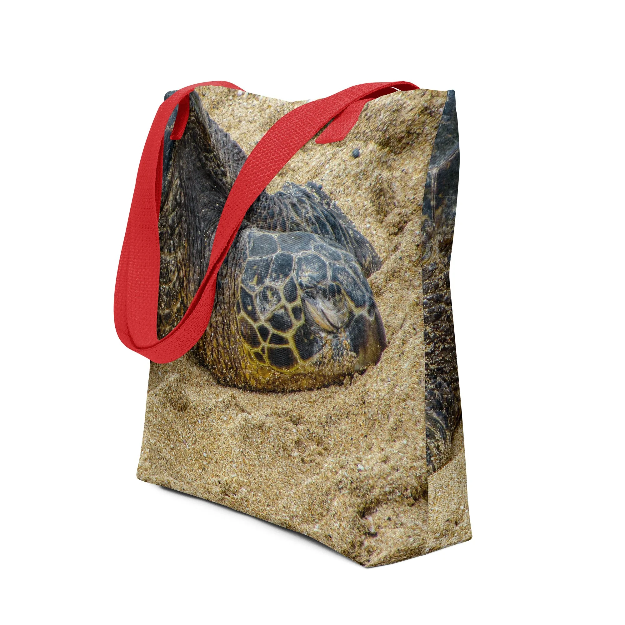 A beautiful Hawaiian tote bag featuring a close-up photograph of a resting sea turtle on warm golden sand. Durable, lightweight, and perfect for beach days, shopping, or daily carry.