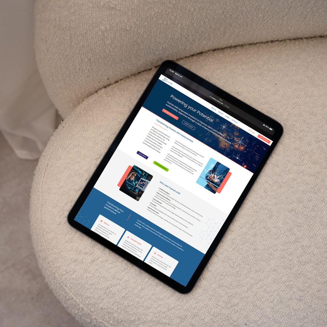 Tablet on a beige upholstered chair displaying a webpage about powering potential and investor measurement.