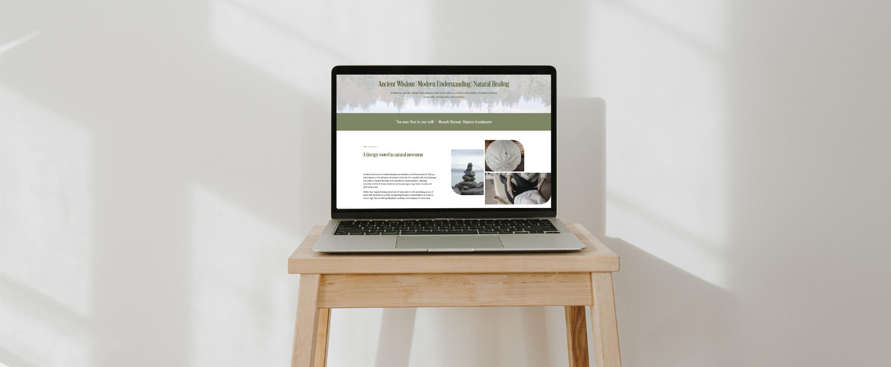 A laptop on a light wooden table against a white wall displaying a webpage related to natural healing and therapy.