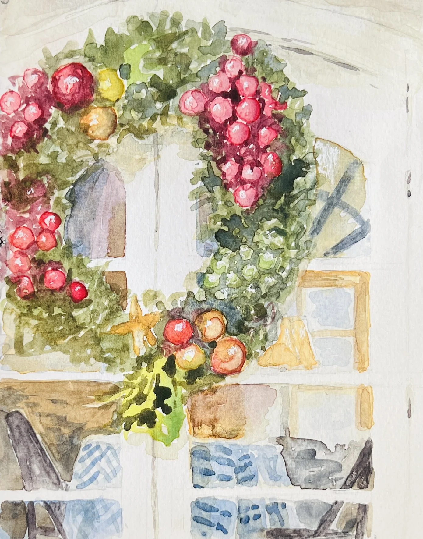Watercolor painting of a Christmas wreath with red, green, and yellow ornaments, hanging on a white wall. The decor is placed on a glass table with various objects around it.