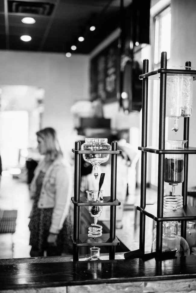 Kyoto Sold Brew set up inside a coffee shop with blurred background.