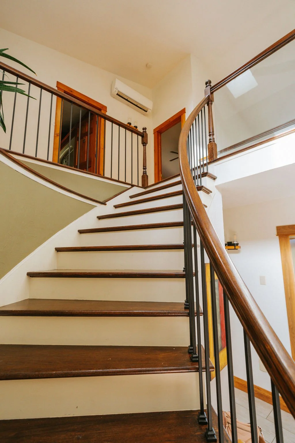 Curved staircase connecting the home’s upper and lower levels.