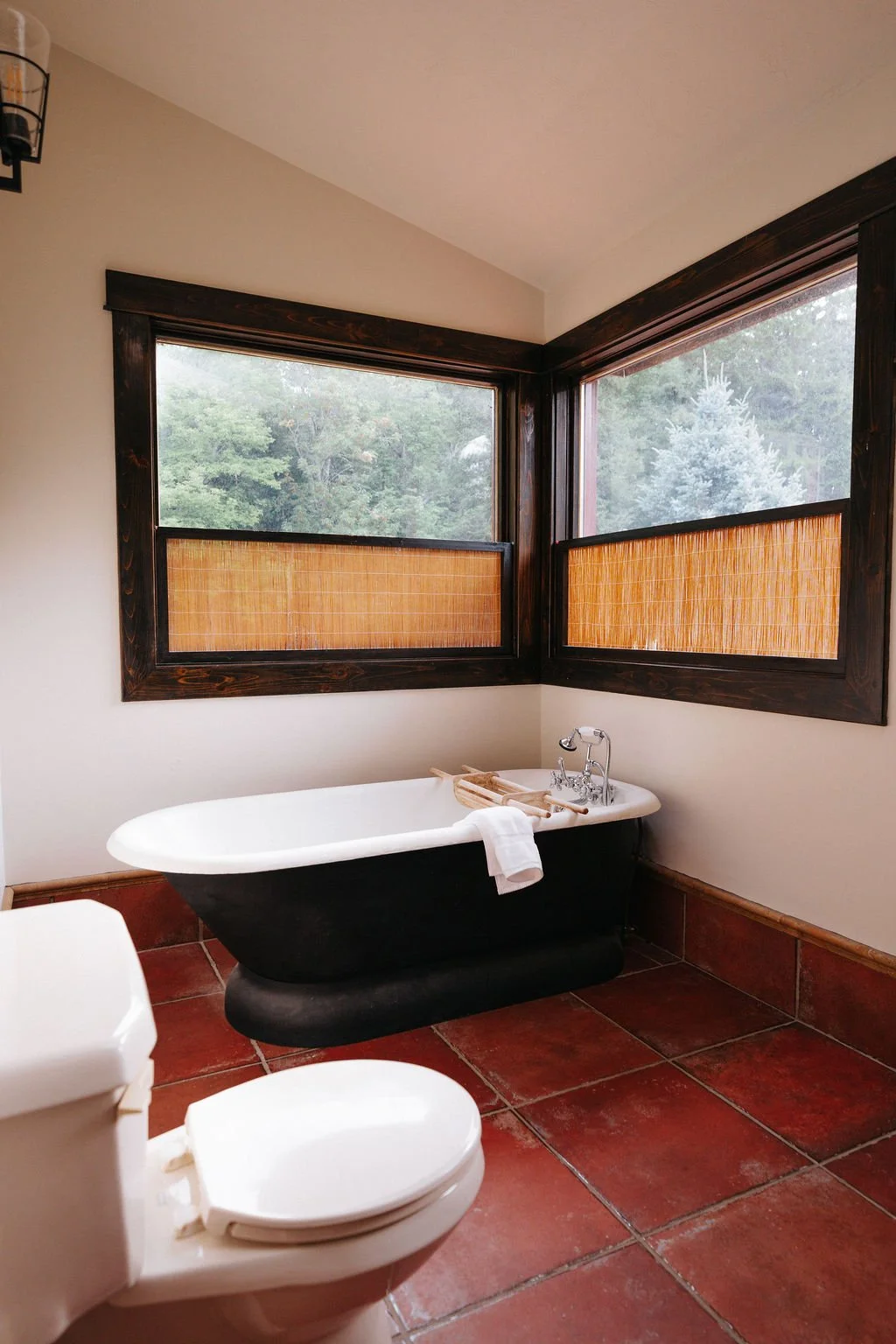 Cozy bathroom with a deep soaker tub and forest views.