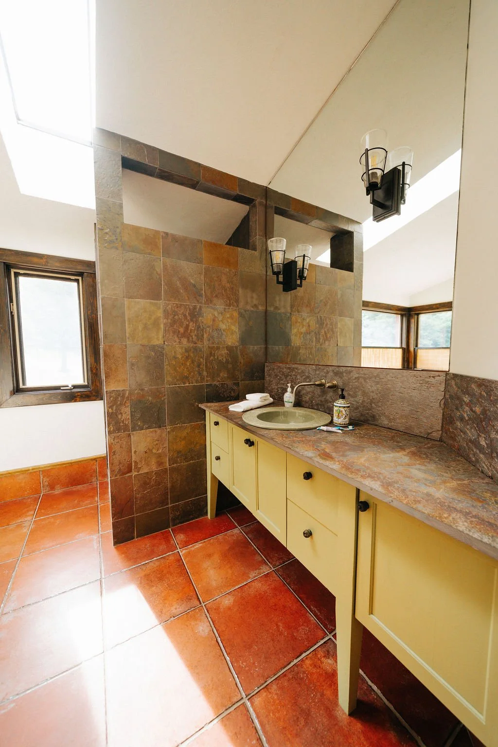 Cozy bathroom with a deep soaker tub and forest views.