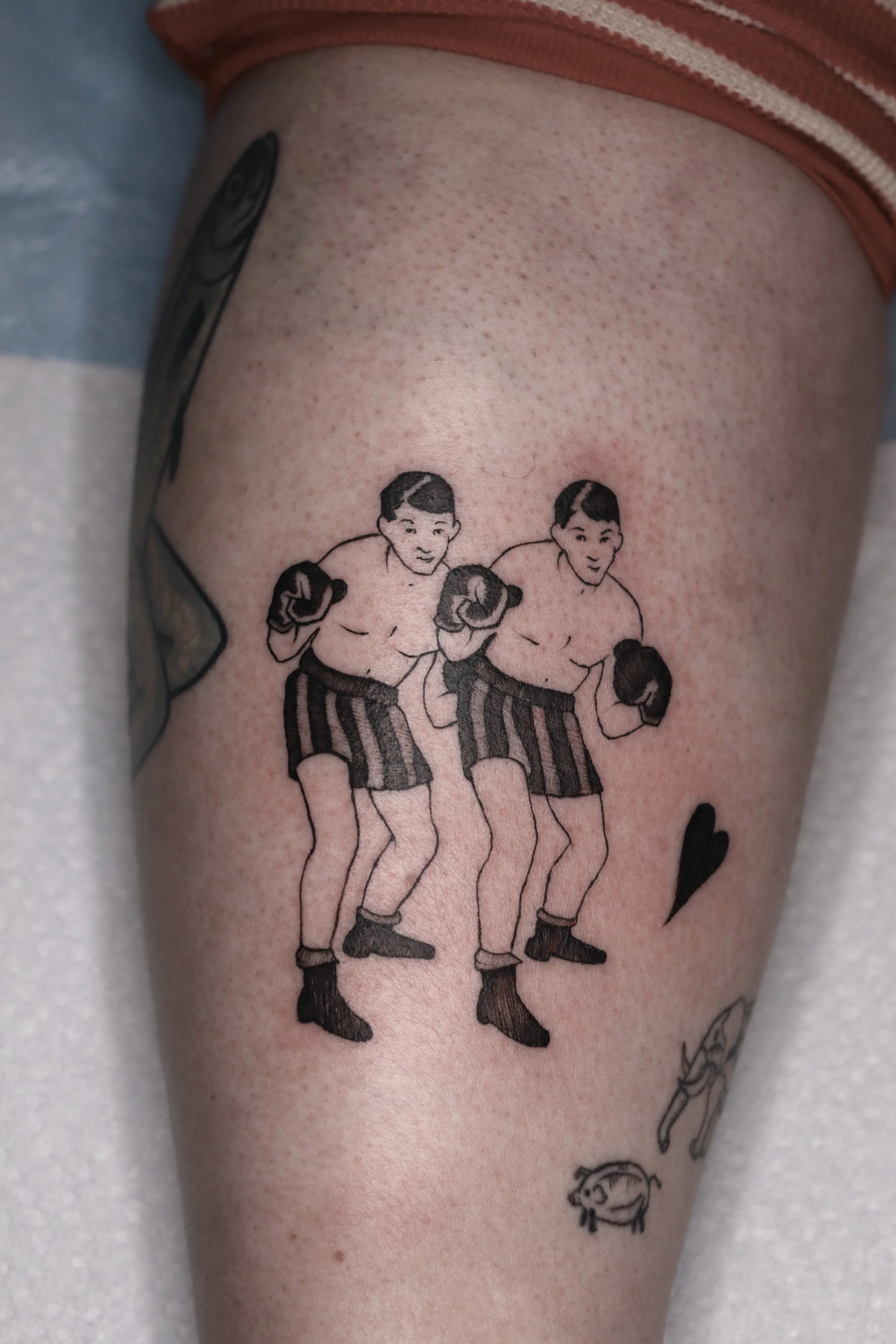 Tattoo of twin boxers posing 