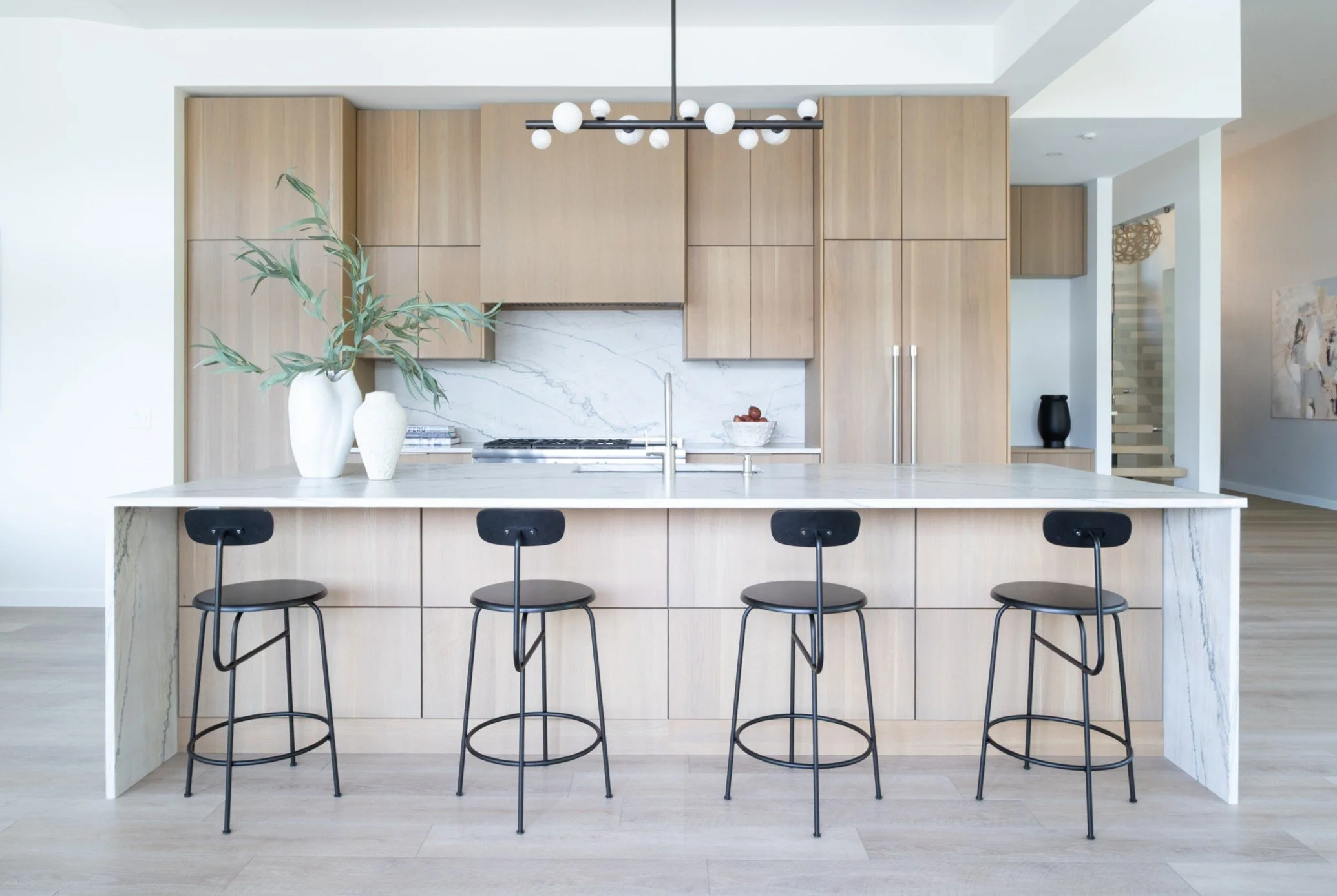 White oak kitchen with marble countertops in custom home, designed by Maise Design Inc.