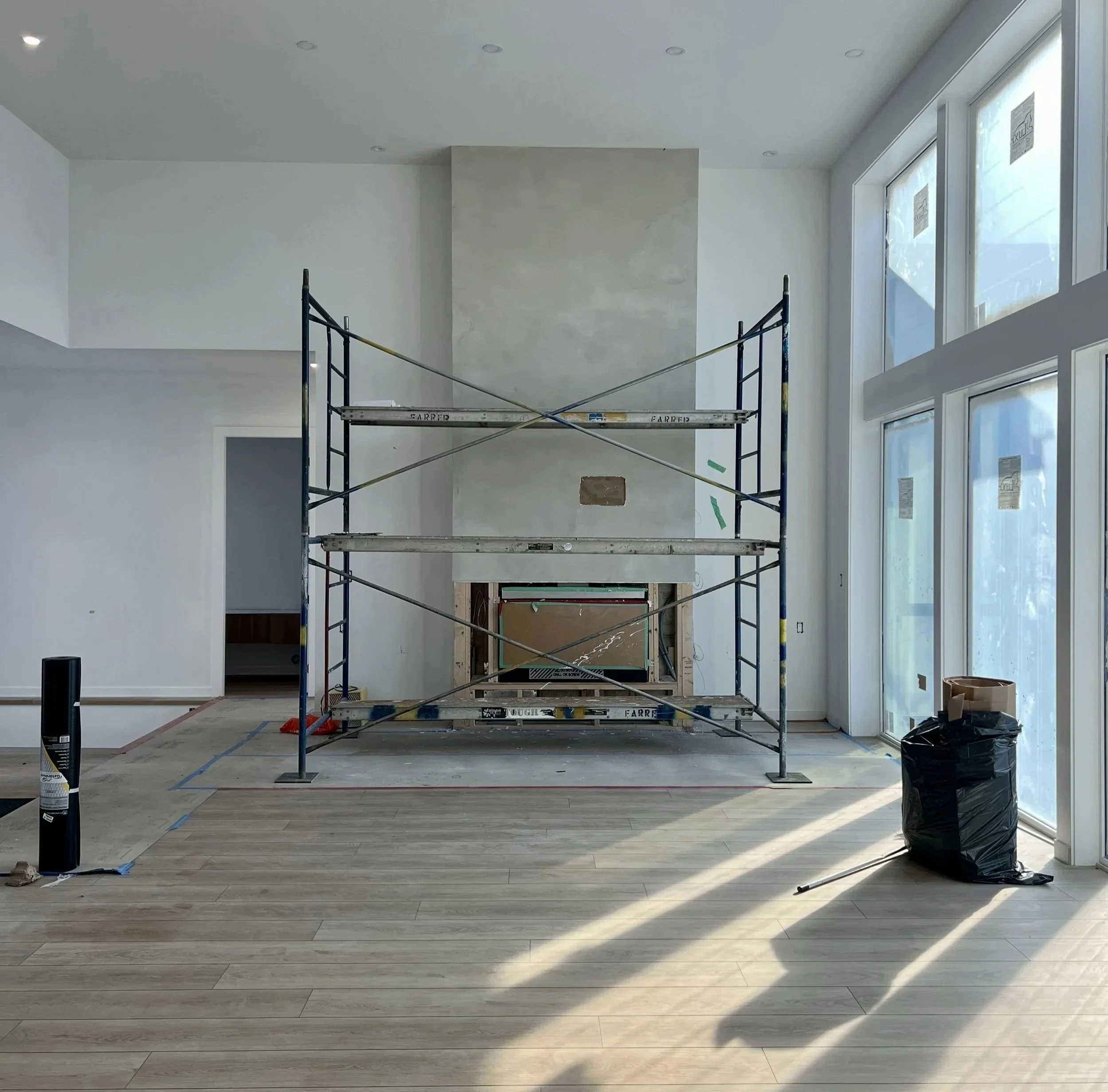 Fireplace with plaster finish, under construction at custom home in Vernon, BC