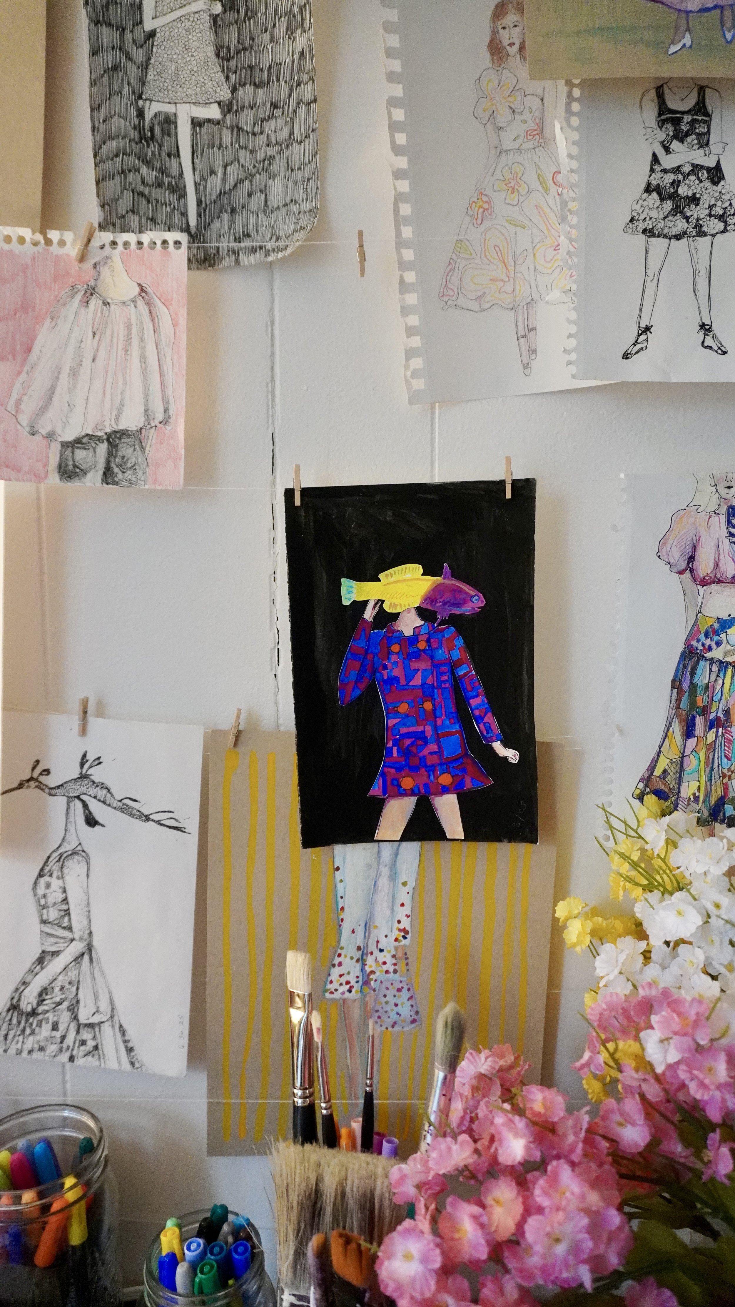 Photo of Jane's Dresses' studio, featuring a girl with a blue and pink patchwork coat and a Royal Gamma Basslet for a head.