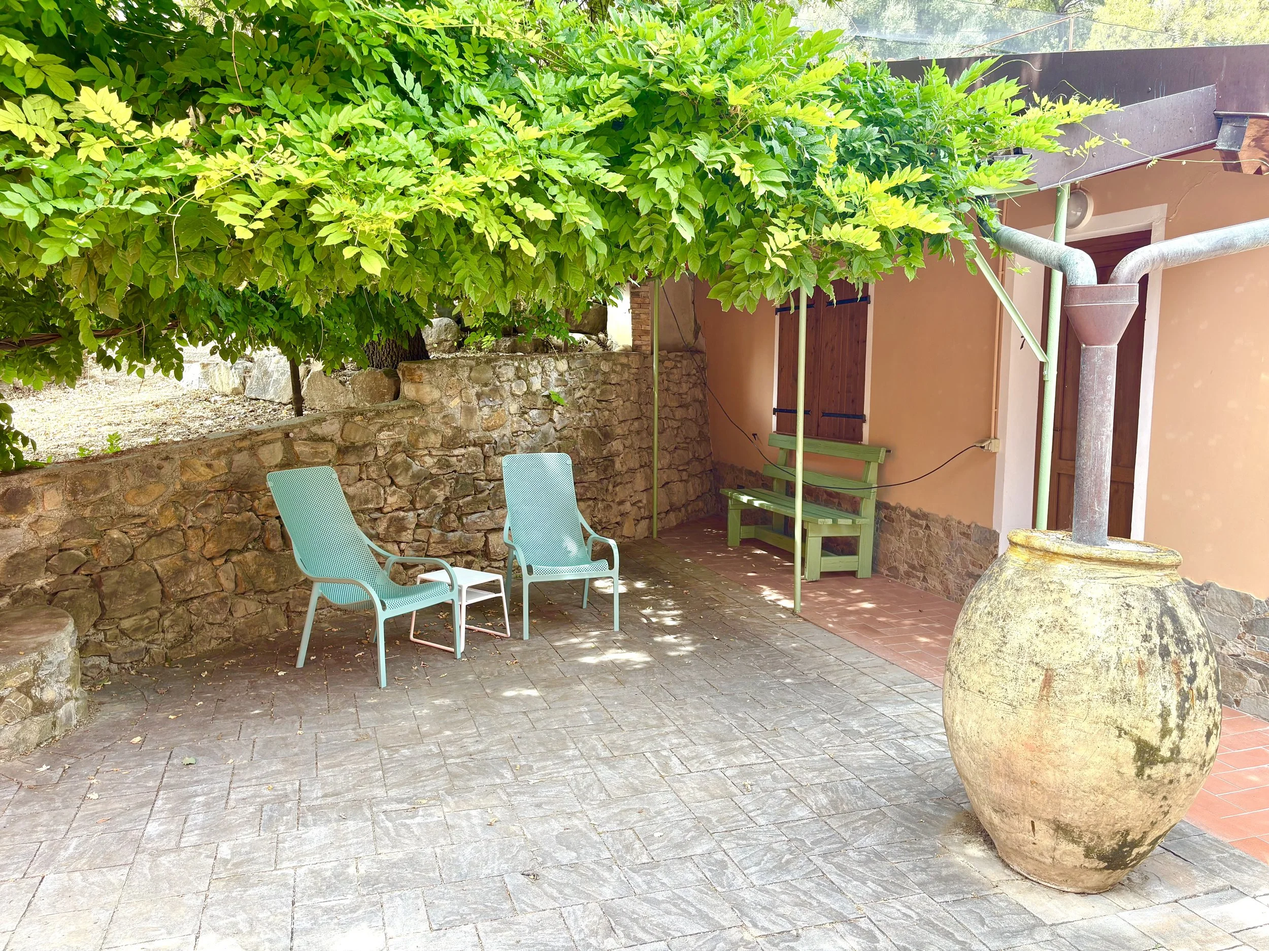 Room 7 at The Club House in Bordighera with private outdoor patio, lounge chairs, and greenery.