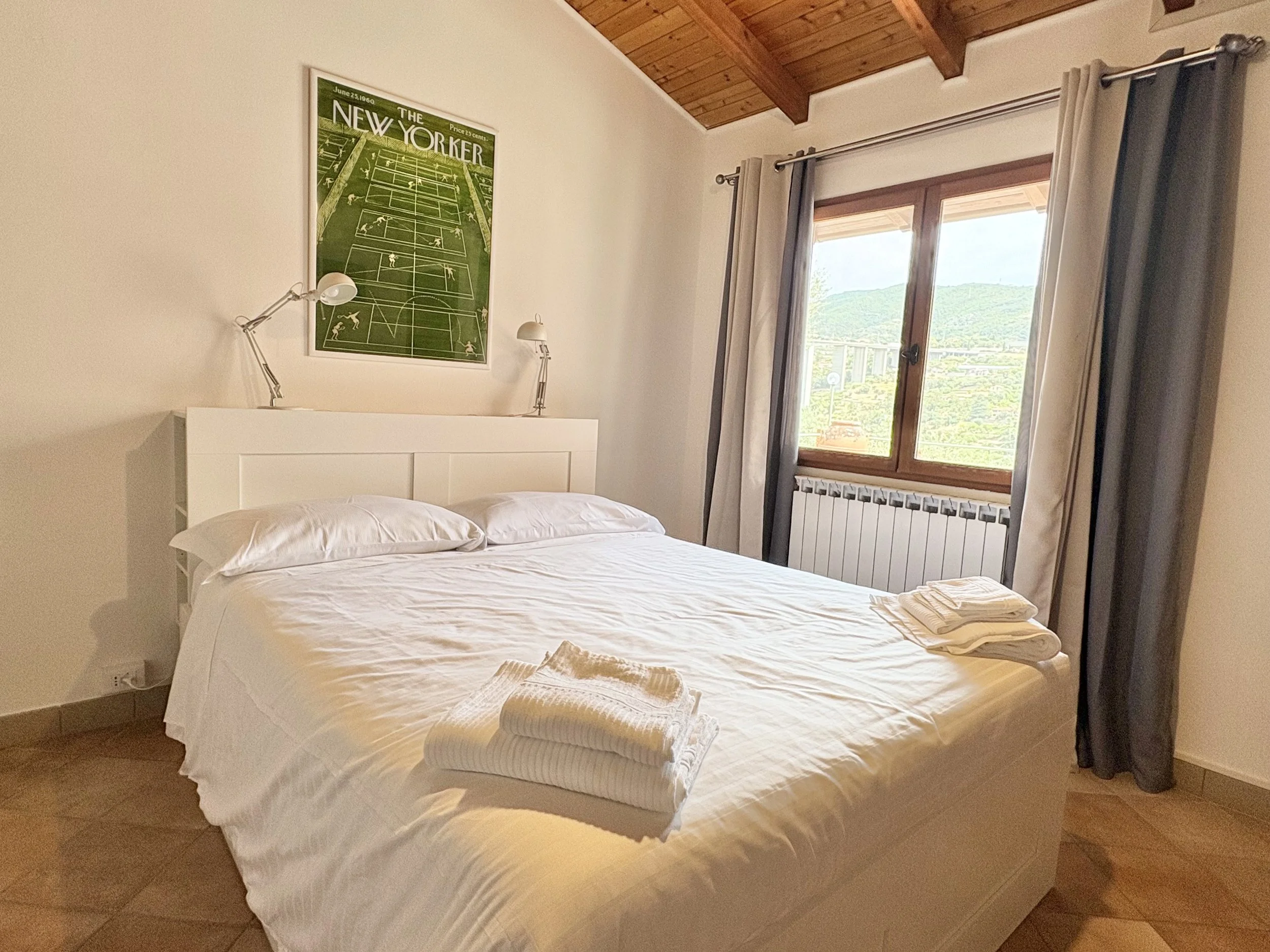 Guest room with hillside views and bright interiors at The Club House Bordighera.