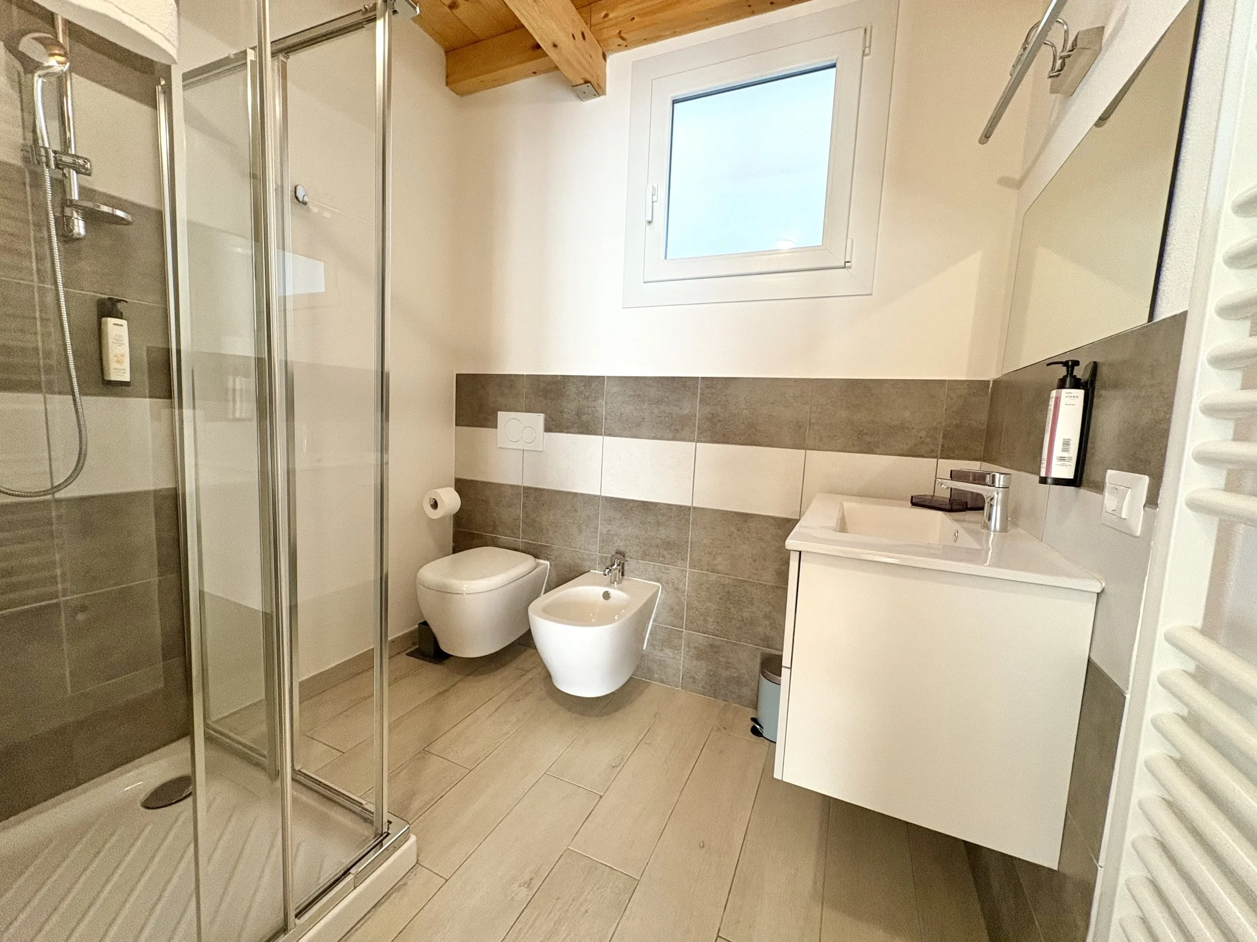 Modern bathroom at The Club House guest rooms in Bordighera with walk-in shower and contemporary fixtures.