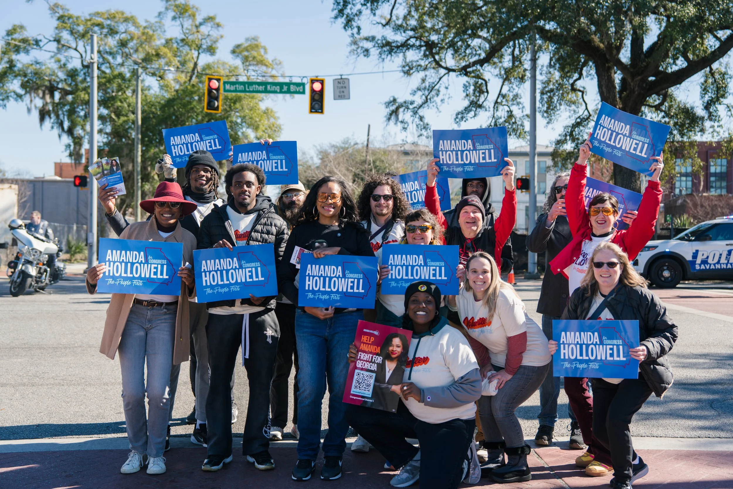Amanda and supporters at a parade holding Amanda Hollowell for Congress signs