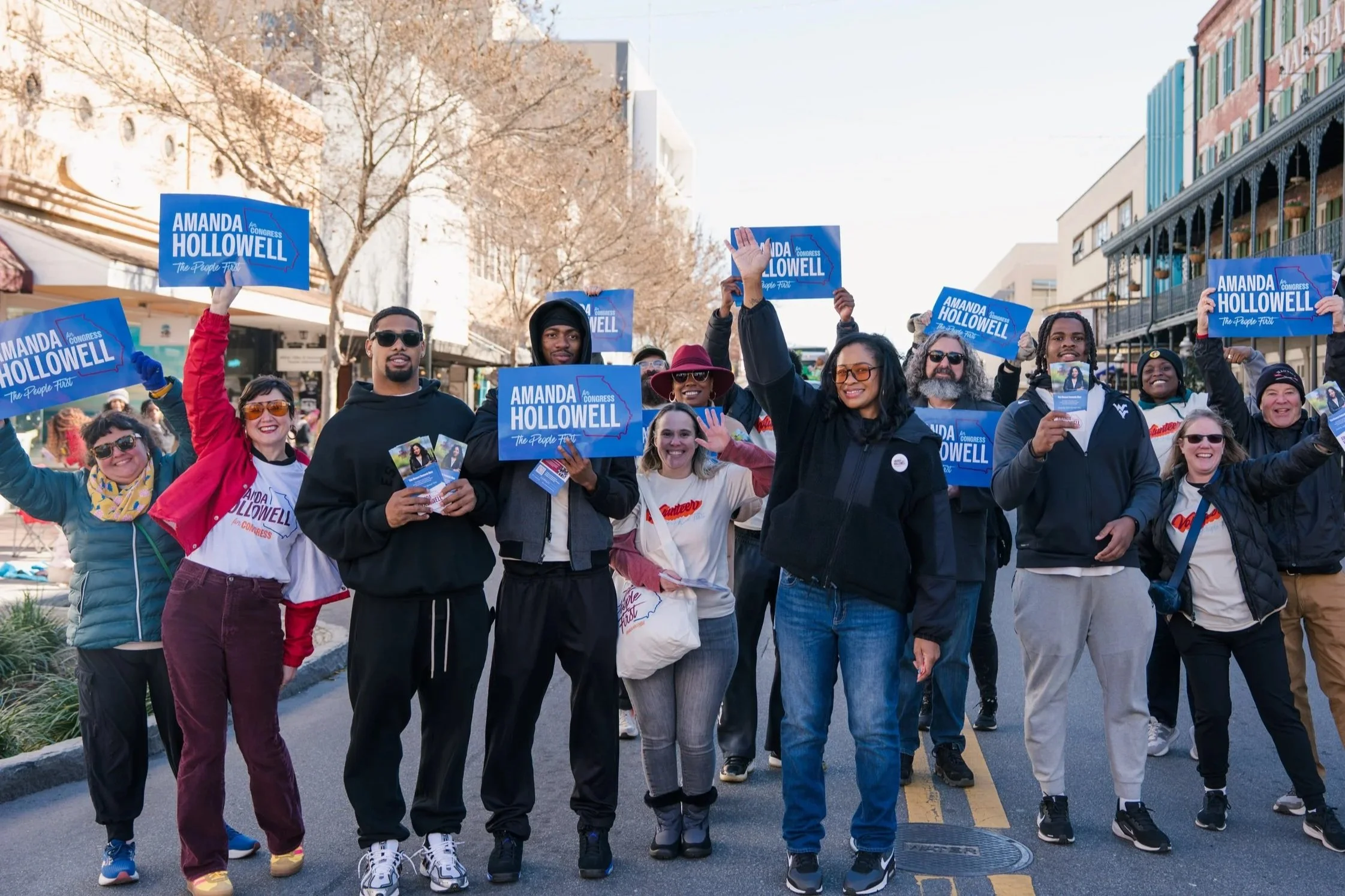 Amanda and her supporters at a parade holding Amanda Hollowell for congress signs