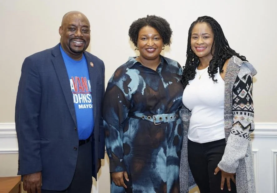 Van Johnson, Stacey Abrams, and Amanda Hollowell standing together