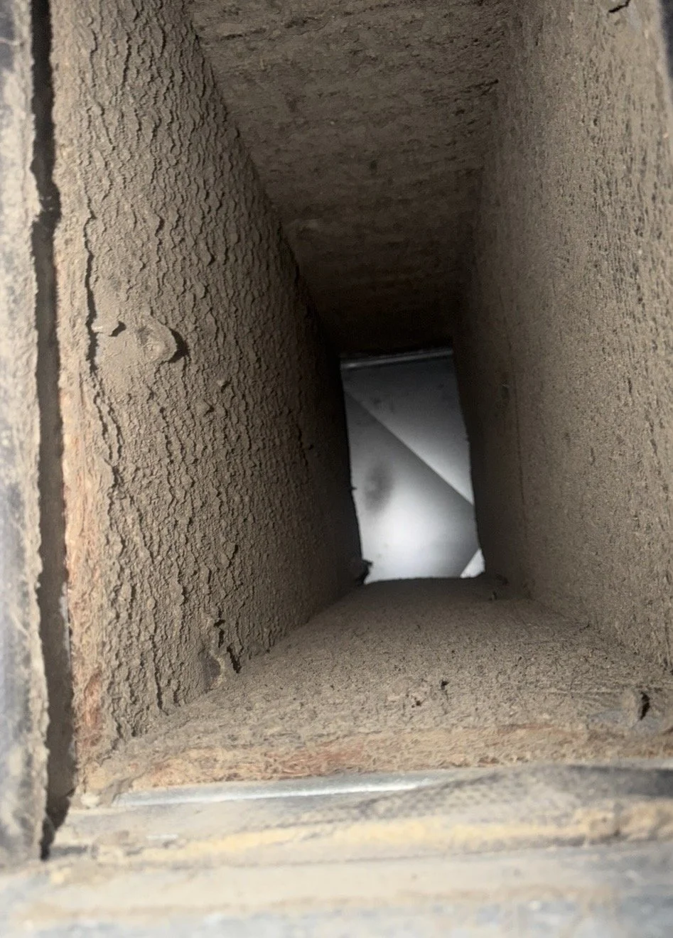 Dust and debris inside air duct before cleaning in Woodbine, Maryland