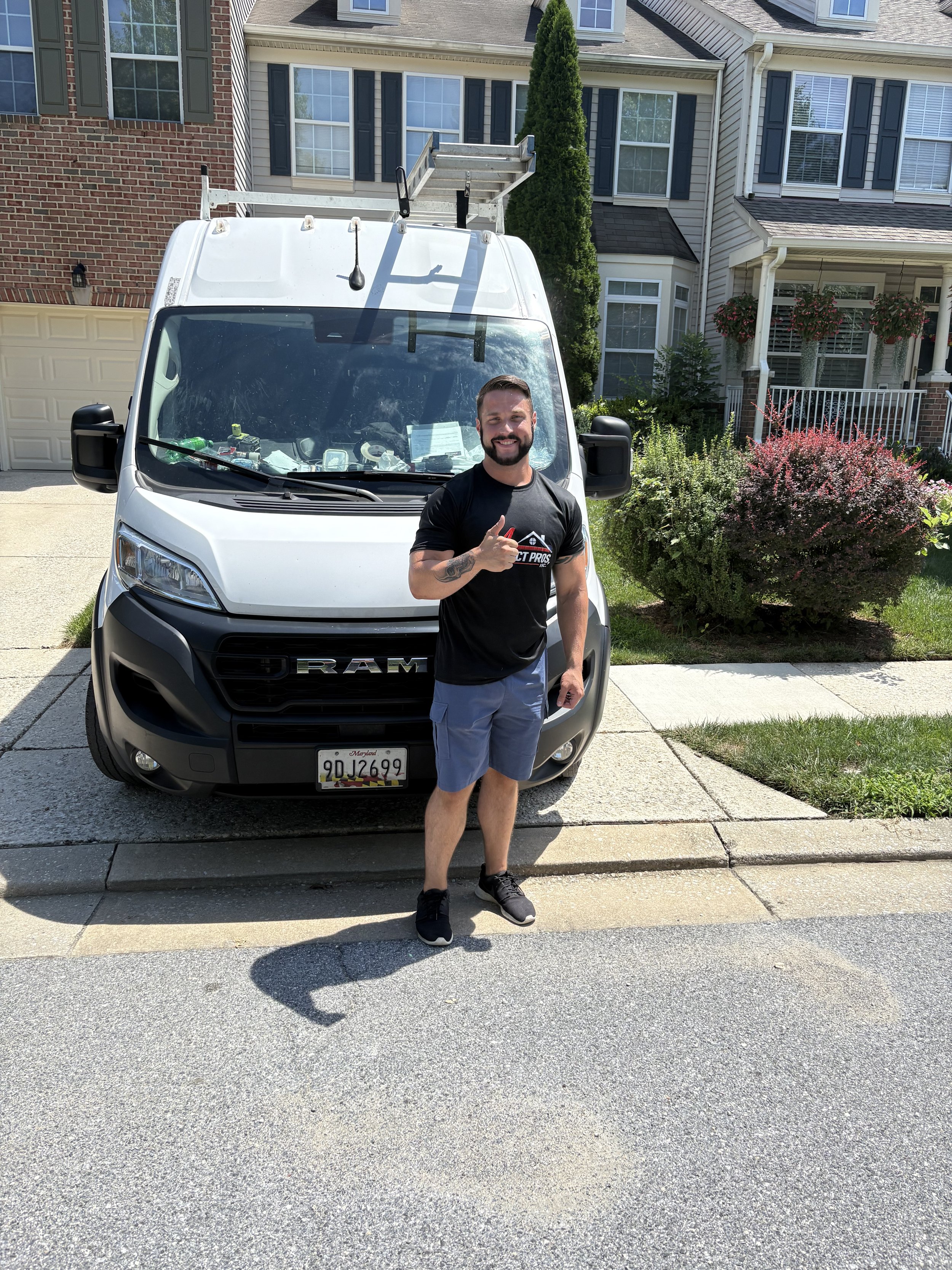 Air Duct Pros, Inc. technician standing in front of a company service van before a residential air duct cleaning appointment in Maryland.