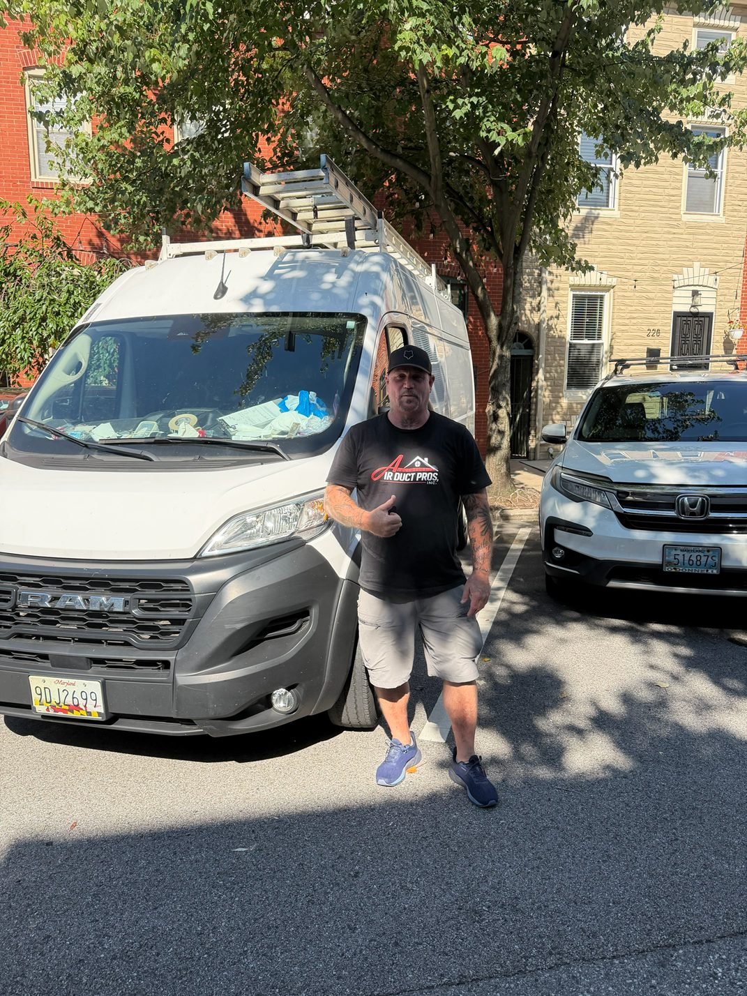 Air Duct Pros, Inc. lead technician standing in front of a company service van at a residential air duct cleaning job in Maryland.