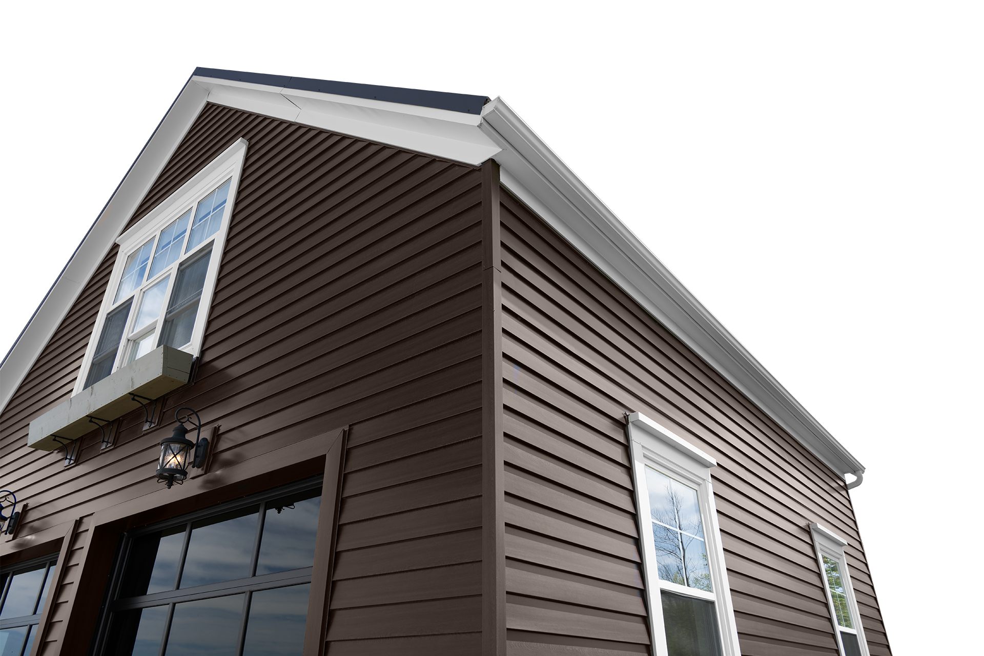 Close-up image of corner of modern brown house with white-framed windows, black lantern-style exterior lights, and white gutters under cloudy sky.