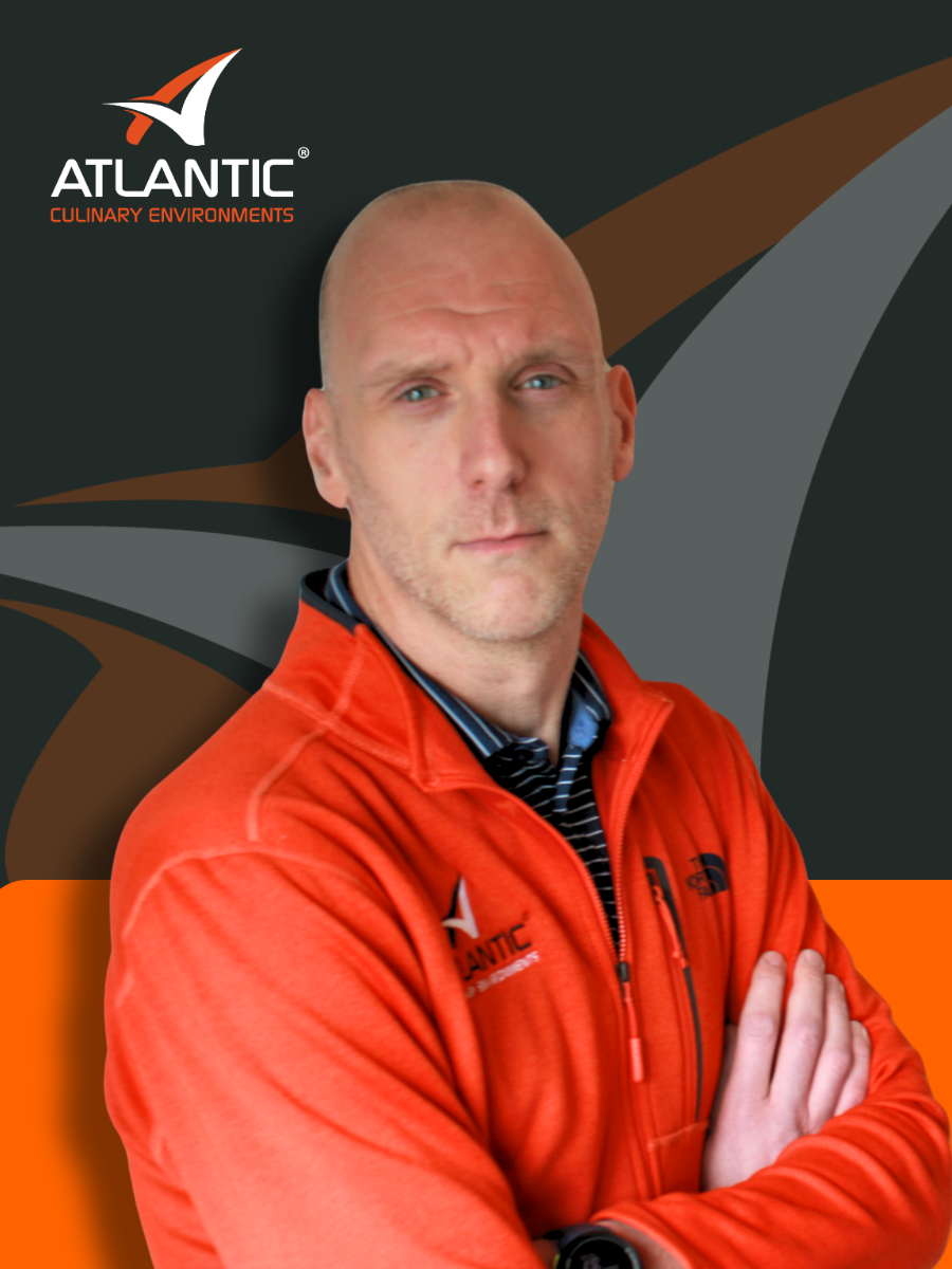 A man with a shaved head and light facial hair wearing a dark gray collared shirt is in front of a background with a logo that reads 'Atlantic Culinary Environments'.