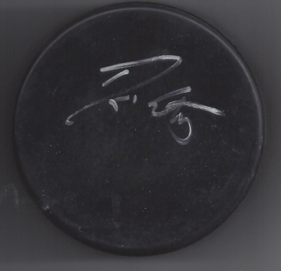 A black circular object with white scribbles or markings on it.