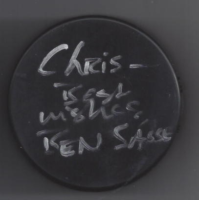 Black circular chalkboard with handwritten notes about chili, meat, and bean sauce.