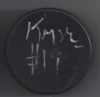 A black vinyl record with handwritten white chalk markings and text.