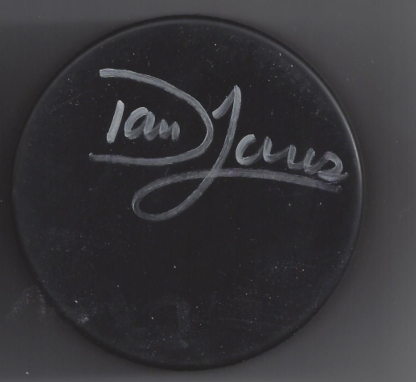 A black circular object with the handwritten words 'Ian' and 'James' on it in white marker.