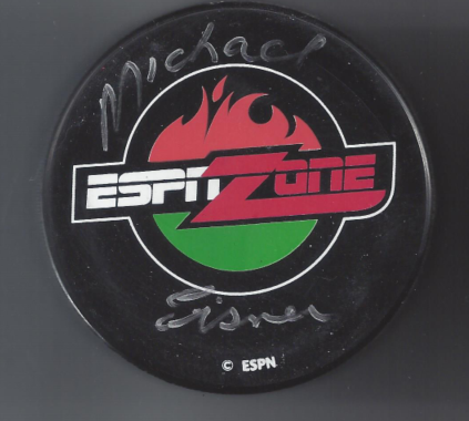 A hockey puck with the ESPN Zone logo and handwritten signatures and the name 'Michael' on it.