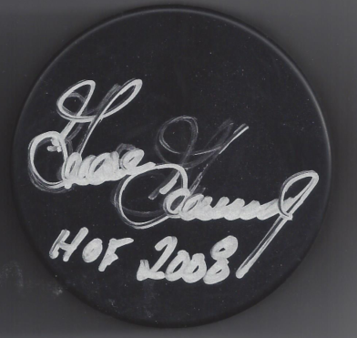 A black hockey puck with a handwritten signature and the inscription 'HOF 2008'.