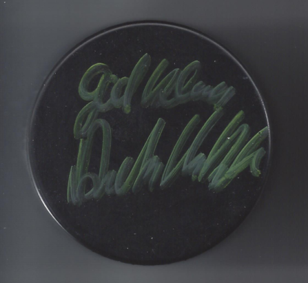 Dark circular object with handwritten green text reading 'Welcome to the North'.