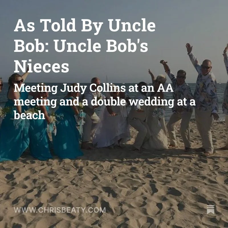 People dancing on a beach with the ocean in the background, dressed in casual, tropical clothing, during a celebration or gathering.