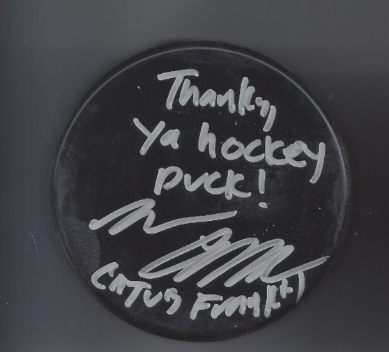 A black hockey puck with a handwritten message that says, "Thanks ya hockey puck!" and is signed by Curtis Funt.