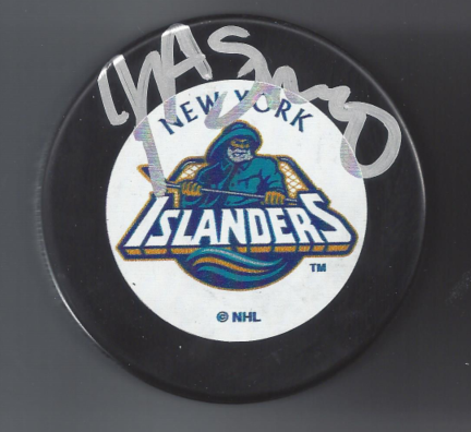 New York Islanders hockey puck with team logo and handwritten signature.