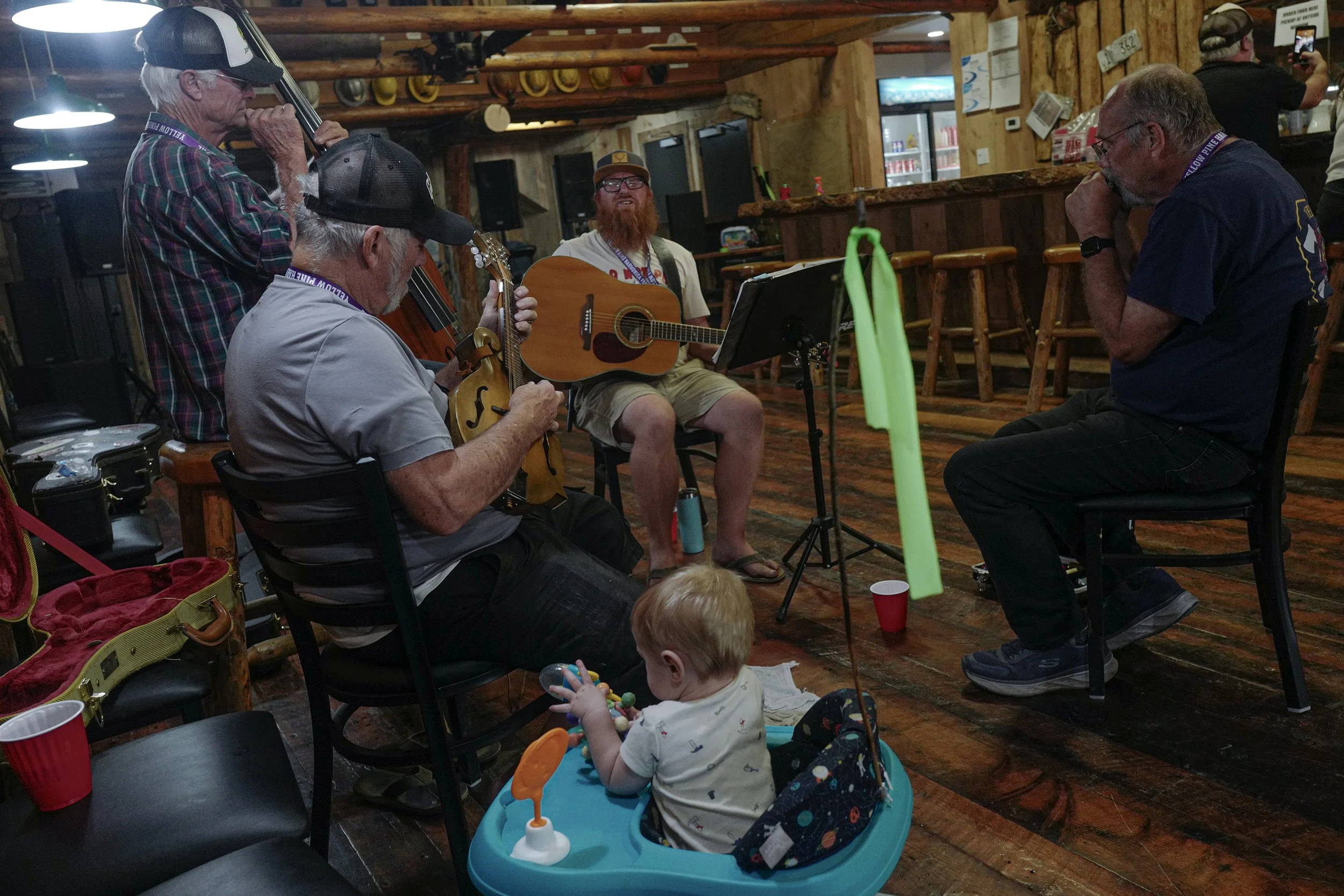 The band - We're Glad to Be Here - plays for patrons in a tavern one afternoon. The Yellow Pine Festival plans a range of activities for adults and children. It's an all inclusive family event.