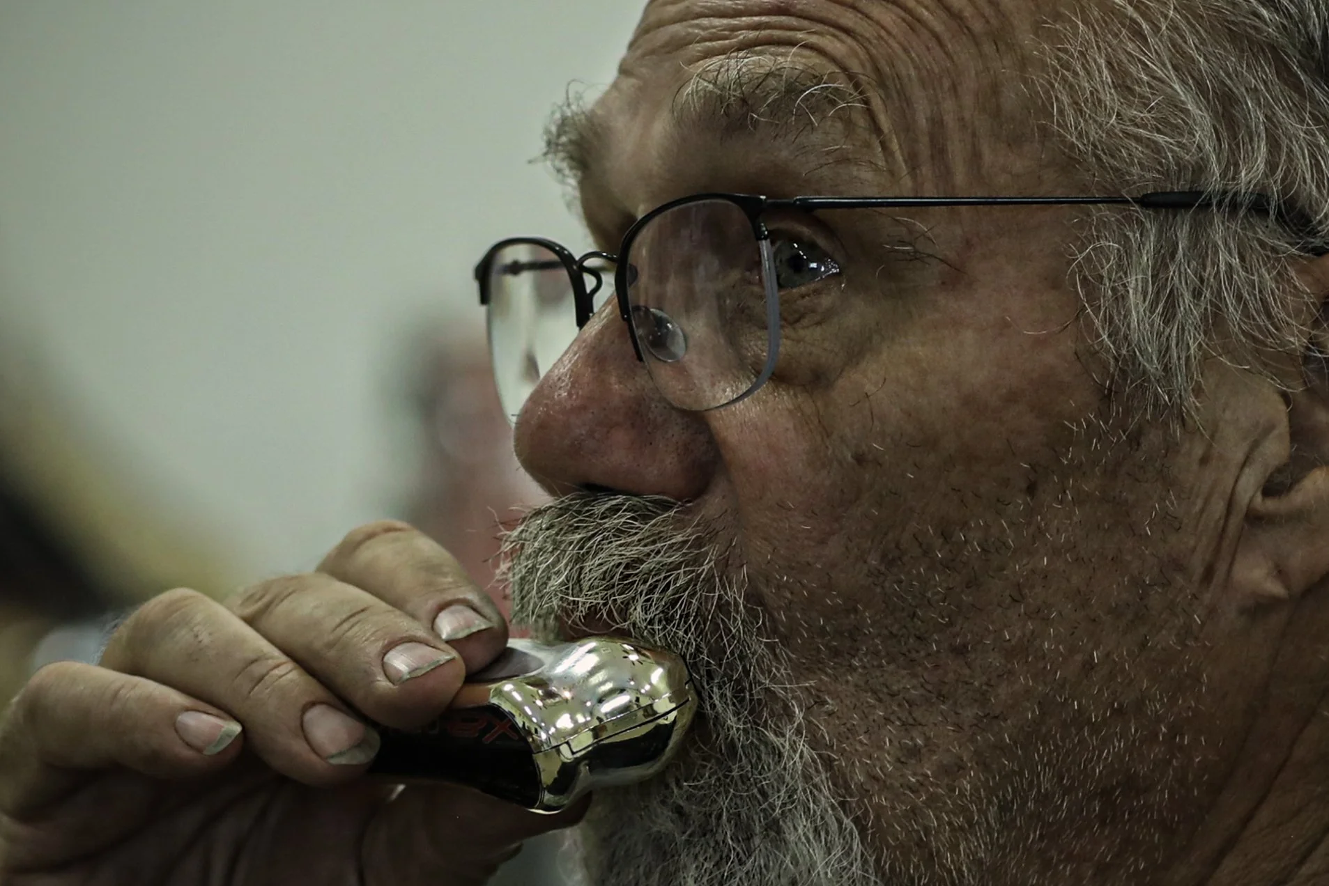 Dennis Cooper from the band - Glad to Be Here - gave lessons on harmonica techniques in the community center.
