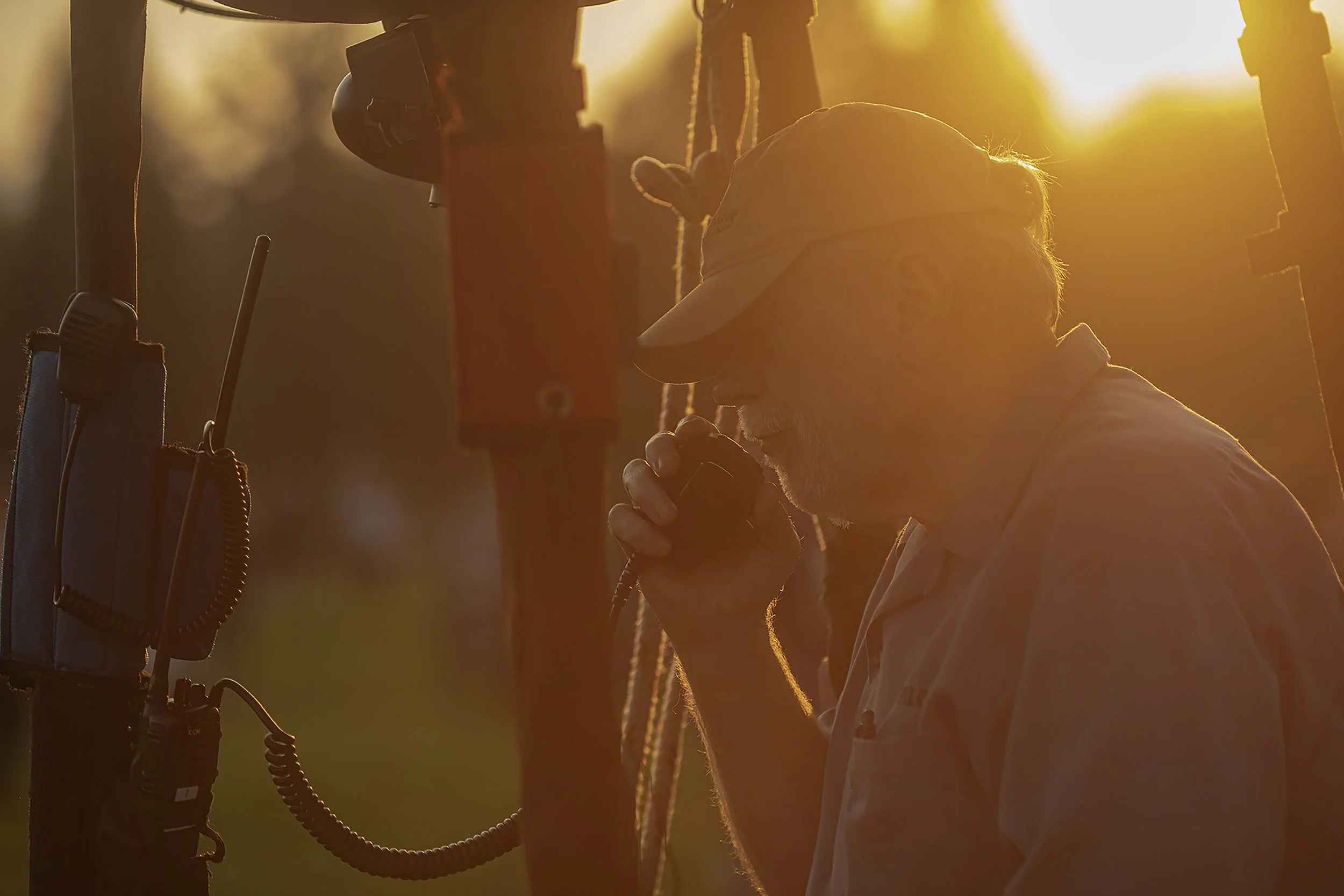 After sunrise, about an hour before flight, Lewin Williams checks his radio connections with crew chief.